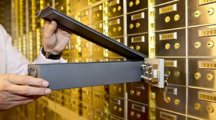 Safe deposit box drawn from a golden wall of boxes